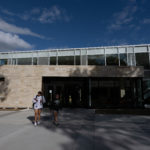 Two students walk outside the front of the Lowry Student Center at The College of ۿ۴ý.