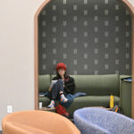 A student studying in the green theme room on the second floor of Lowry Center at The College of ۿ۴ý.